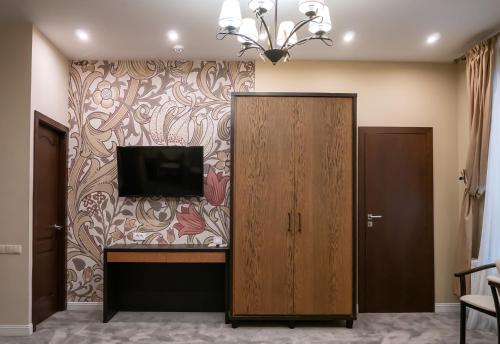 a room with a tv on a wall at Shato Luxe in Odesa