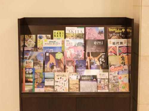 a display case filled with books on a wall at Richmond Hotel Akita Ekimae in Akita