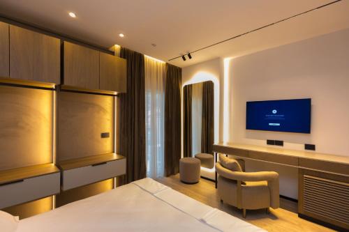 a hotel room with a bed and a television at Diora'S Hotel and Apartments in Vlorë