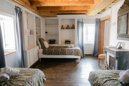 a bedroom with two beds and a fireplace at Château de Lemps in Lemps