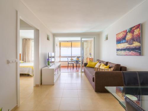 a living room with a couch and a table at Amanecer Playa Patalavaca in Patalavaca