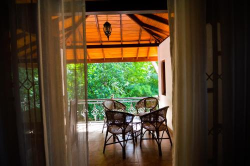 a dining room with a table and chairs on a porch at Binara Home Stay in Polonnaruwa
