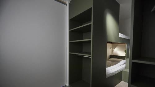 a bedroom with a closet with a bed in it at Het Kasterhuis in Wetteren