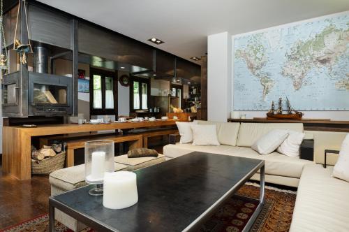 a living room with a large map on the wall at Terra Lodge in Hoz de Jaca