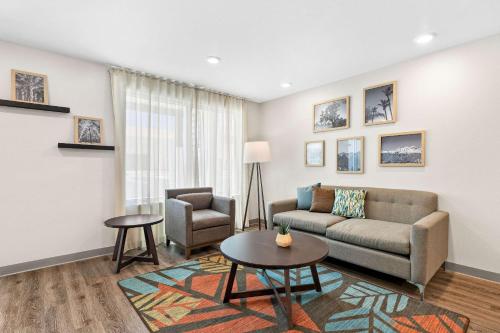 a living room with a couch and a chair at WoodSpring Suites Indio - Coachella Valley in Indio