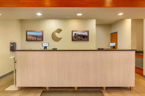 a lobby with a large counter with a c sign on the wall at Comfort Inn & Suites Rapid City near Mt Rushmore in Rapid City