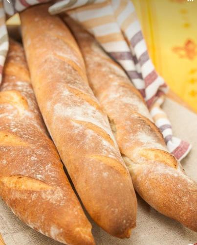 a group of breadsticks sitting on top of a table at Hôte Labyrinthe lit 180 cm salle de bain, petit dej compris in Mirepoix