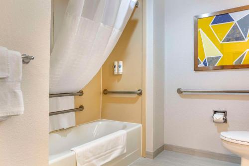 a bathroom with a bath tub and a toilet at Comfort Inn & Suites Rapid City near Mt Rushmore in Rapid City