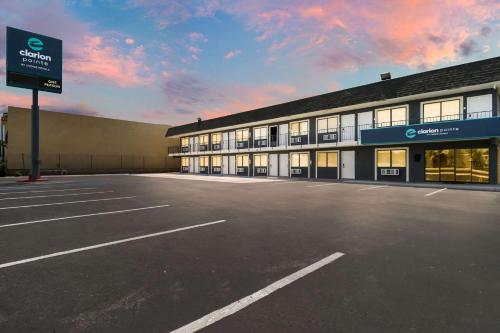 an empty parking lot in front of a building at Clarion Pointe Ridgecrest near China Lake Naval Station in Ridgecrest