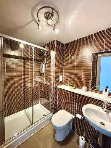 a bathroom with a shower and a toilet and a sink at Golf View in Prestwick
