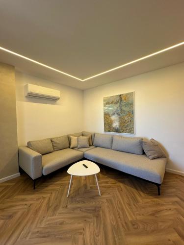 a living room with a couch and a table at Brand New Apartament in Golem