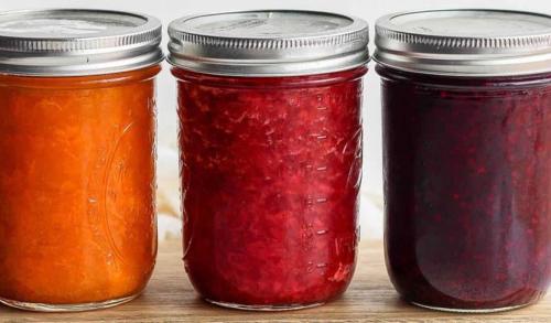 a group of four jars of jam on a table at Hôte Labyrinthe lit 180 cm salle de bain, petit dej compris in Mirepoix