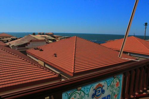 a group of roofs with the ocean in the background at Grand Hotel Ras Elbar in Ras El Bar