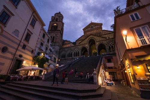 a group of people walking up the stairs of a building at Amalfi Luxury House in Amalfi