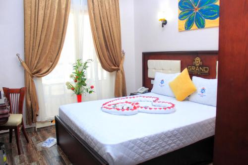 a bedroom with a bed with a cake on it at Grand Hotel Ras Elbar in Ras El Bar