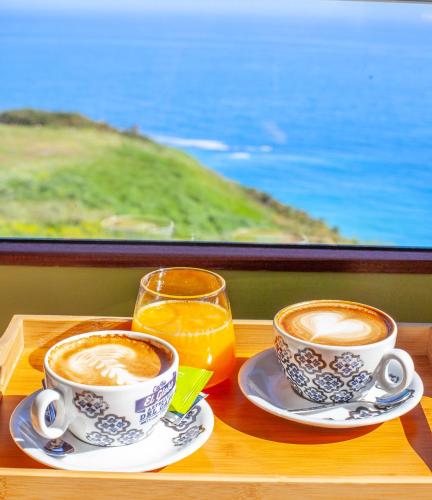 two cups of coffee and a glass of orange juice at La Colina in Gijón