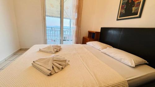 a bed with two pillows on it in a bedroom at Emy Studios in Fanárion