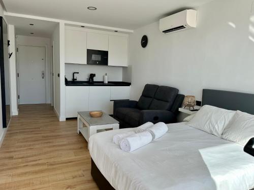 a bedroom with a bed and a living room at Apartamento Bambú in Torre del Mar