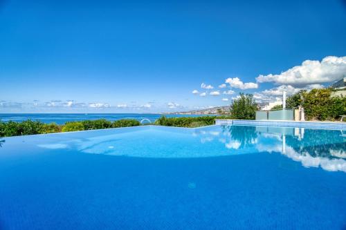 a swimming pool with a view of the water at Seafront Villa 2 in Paphos City