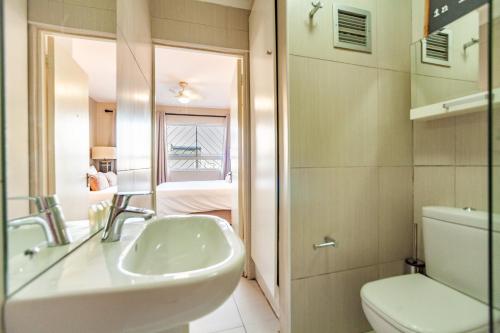 a bathroom with a sink and a toilet at Beachfront Luxury Living- A106 Seaspray, Blouberg in Bloubergstrand