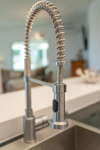 a kitchen sink with a chrome kitchen faucet at Villa Vista Verde Mijas Golf - Luxury with Optional heated pool & jacuzzi in Mijas