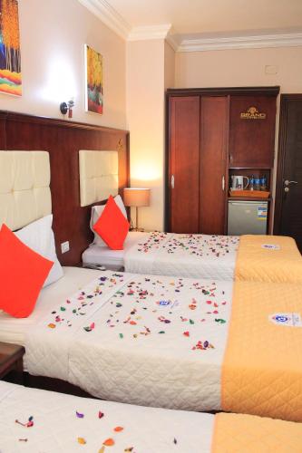 a hotel room with two beds with flowers on them at Grand Hotel Ras Elbar in Ras El Bar