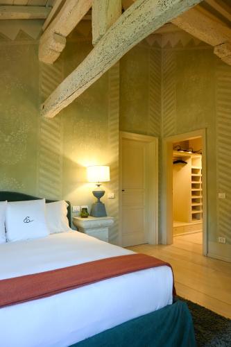 a bedroom with a large white bed in a room at Elizabeth Country House, a Member of Design Hotels in Minerbio