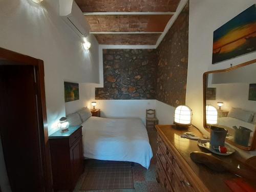 a bedroom with a bed and a vanity with a mirror at Pilarella Gallery trilocale vistamare in Porto Santo Stefano