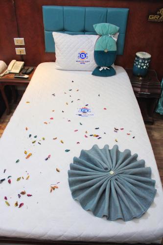 a bed with confetti on it with a blue head board at Grand Hotel Ras Elbar in Ras El Bar