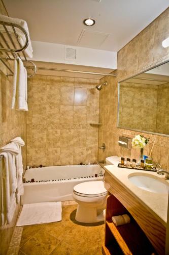 a bathroom with a tub and a toilet and a sink at Hotel Mulberry in New York