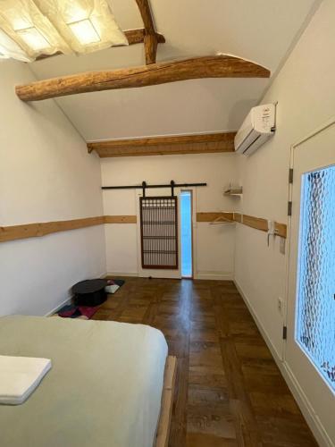 a room with a bed and a wooden floor at Eoulim House in Andong