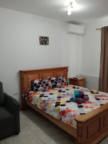 a bed with a colorful comforter and stuffed animals on it at Jeni's studio in Constanţa