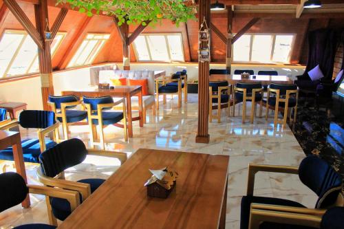 a dining room with tables and chairs and windows at Grand Hotel Ras Elbar in Ras El Bar