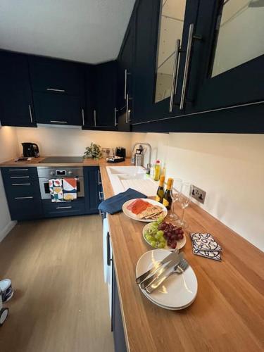 a kitchen with a counter with plates of food on it at Elegant Flat in Oxford Center with Parking in Oxford
