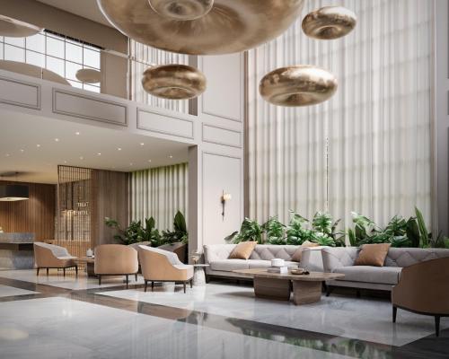 a lobby with a couch and chairs and plants at Treat Hotel Nashik City Center in Nashik