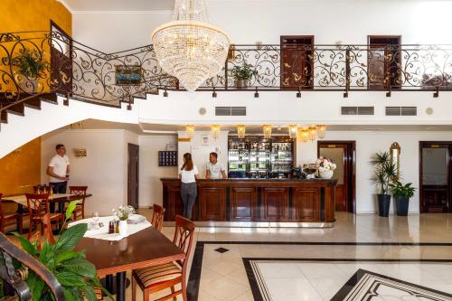 a lobby of a restaurant with people standing at a bar at Guest Accommodation Atrium Gulin in Lozovac