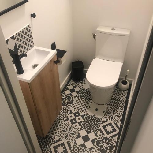 a bathroom with a toilet and a sink at La Joueuse, Et pop Et Chic ! in Poitiers