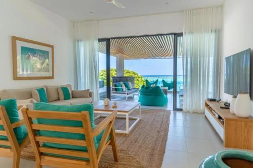 a living room with a couch and a table at Blue Nest Luxury Penthouse in Blue Bay