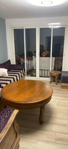 un salon avec une table en bois et un canapé dans l'établissement Chambre privée, à Aix-en-Provence