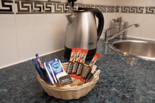 a basket of toothbrushes and toothpaste on a counter at Grand Plaza Serviced Apartments in London
