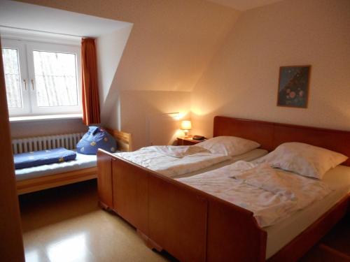 a bedroom with two beds and a window at Ferienhof Bisdorf "Leuchtturm" in Bisdorf