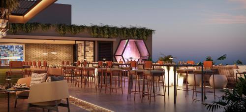 a restaurant with a bunch of chairs and tables at Treat Hotel Nashik City Center in Nashik