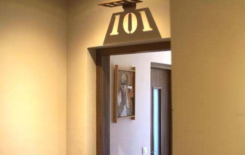 a mirror in a hallway with a light above it at Nosy Manga - Hotel Ivato Airport in Antananarivo