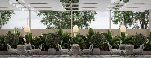 a conference room with chairs and purple plants at Treat Hotel Nashik City Center in Nashik