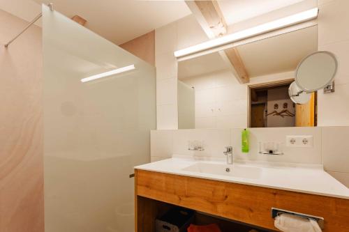 a bathroom with a sink and a mirror at Ferienwohnungen Knaller-Möd in Weissensee