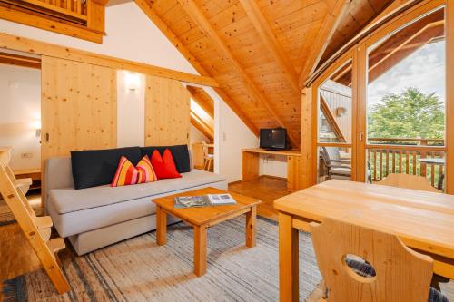 a living room with a couch and a table at Ferienwohnungen Knaller-Möd in Weissensee