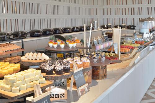 a bakery with many different types of cakes and pastries at Treat Hotel Nashik City Center in Nashik
