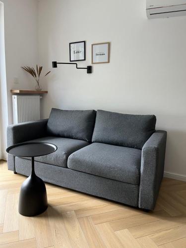 a living room with a couch and a table at Apartament Sun in Sztutowo