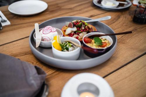 a plate of food on top of a wooden table at Rajskie Jabłka - azyl dla dorosłych in Lubomierz
