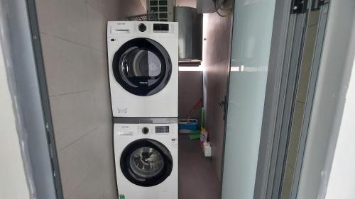 a washing machine and a dryer in a room at Vinh Hoi Apartments - Luxury Apartment Furnished Suites in Ho Chi Minh City